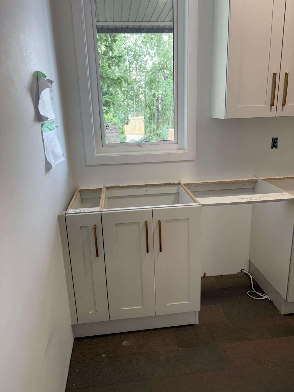 White shaker cabinets with gold hardware
